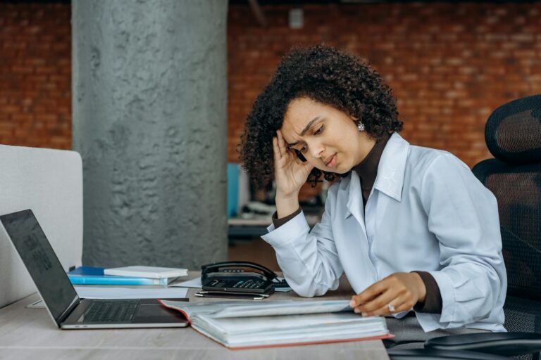 an exhausted woman reading documents